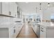 Open concept kitchen showcases stone countertops and stainless steel appliances at 6851 Copper Sky Cir, Castle Pines, CO 80108