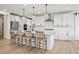 Large gourmet kitchen featuring a center island, bar seating, and stainless steel appliances at 6851 Copper Sky Cir, Castle Pines, CO 80108