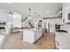 Spacious open kitchen with a large island, bar seating, stainless appliances and access to the living room at 6851 Copper Sky Cir, Castle Pines, CO 80108