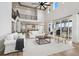 Open concept living room with high ceilings and black metal stair railing at 6851 Copper Sky Cir, Castle Pines, CO 80108