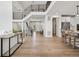 Open-concept floor plan with wood floors, a modern staircase, and white walls at 6851 Copper Sky Cir, Castle Pines, CO 80108