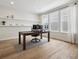 Bright home office with large windows, hardwood floors, and custom shelving, creating an ideal workspace at 6851 Copper Sky Cir, Castle Pines, CO 80108