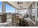 Spacious covered patio with dining area, ceiling fans, and scenic views, perfect for outdoor gatherings at 6851 Copper Sky Cir, Castle Pines, CO 80108