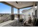 Covered patio with a cozy seating area, modern fire pit, and scenic views for relaxing and enjoying the outdoors at 6851 Copper Sky Cir, Castle Pines, CO 80108
