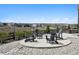 Outdoor patio featuring stone ground cover and four Adirondack chairs with beautiful neighborhood views at 6851 Copper Sky Cir, Castle Pines, CO 80108
