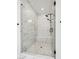 Modern walk-in shower with white subway tile, glass door, and built-in bench at 6851 Copper Sky Cir, Castle Pines, CO 80108