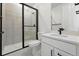 Modern bathroom with white cabinets, quartz counters, black hardware, and glass-enclosed shower at 16549 Black Rose Cir, Parker, CO 80134