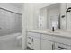 Modern bathroom features a tub/shower combo, large format tiling, quartz counters and matte black hardware at 16549 Black Rose Cir, Parker, CO 80134