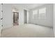 Spacious bedroom with three windows and a view into an ensuite bathroom at 16549 Black Rose Cir, Parker, CO 80134