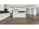 Bright kitchen featuring white cabinets, a large island, stainless steel appliances, and dark backsplash at 16549 Black Rose Cir, Parker, CO 80134