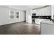Well lit kitchenette features modern white cabinets, dark countertops, and stainless steel appliances at 16549 Black Rose Cir, Parker, CO 80134