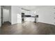 Open concept kitchenette featuring dark wood floors, modern white cabinetry, and black countertops at 16549 Black Rose Cir, Parker, CO 80134