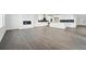Open-concept living space with fireplace, flowing into the bright kitchen with island and modern appliances at 16549 Black Rose Cir, Parker, CO 80134