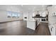 Open-concept living space with modern kitchen, island, hardwood floors, and plenty of natural light at 16549 Black Rose Cir, Parker, CO 80134