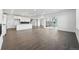 Open-concept floor plan featuring a modern kitchen and living room with hardwood floors and natural light at 16549 Black Rose Cir, Parker, CO 80134