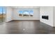 Bright living space featuring a modern fireplace, hardwood floors, and large windows with views at 16549 Black Rose Cir, Parker, CO 80134