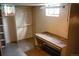 Basement storage area with shelving, workbench, and small window at 5431 S Hickory St, Littleton, CO 80120