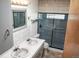 Bathroom featuring a double sink vanity and updated shower at 5431 S Hickory St, Littleton, CO 80120