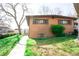 Charming brick home with a well-maintained lawn and a walkway leading to the front entrance at 5431 S Hickory St, Littleton, CO 80120