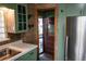 Kitchen featuring durable countertops, stainless steel appliances, and a view into the doorway at 5431 S Hickory St, Littleton, CO 80120