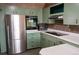 Well-equipped kitchen with stainless steel refrigerator and updated appliances at 5431 S Hickory St, Littleton, CO 80120