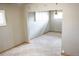 Open living room featuring neutral walls, carpet, and a partial view into an adjacent space with shuttered windows at 5431 S Hickory St, Littleton, CO 80120