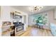 Modern kitchen featuring stainless steel appliances, custom shelves, and an adjacent dining area at 4430 S Cherokee St, Englewood, CO 80110