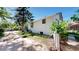 Exterior view of the home, highlighting a spacious side yard and mature trees at 4430 S Cherokee St, Englewood, CO 80110