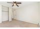 Comfortable bedroom with a ceiling fan, neutral carpet, and a convenient closet at 2231 S Vaughn Way # 317 B, Aurora, CO 80014