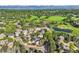 Aerial view of the neighborhood with lush greenery, golf course, and pond at 360 Morning Star Ln, Lafayette, CO 80026