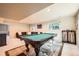 Basement showcasing a pool table with green felt and decorative legs, with view of couch and windows at 360 Morning Star Ln, Lafayette, CO 80026