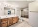 Bathroom featuring a dual sink vanity with storage and a shower with sliding glass doors at 360 Morning Star Ln, Lafayette, CO 80026