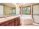 Main bathroom with double sinks, soaking tub, and separate shower at 360 Morning Star Ln, Lafayette, CO 80026