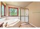 Bathroom featuring a soaking tub with a tiled surround and a glass-enclosed shower at 360 Morning Star Ln, Lafayette, CO 80026