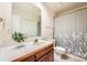 Bathroom with a single sink vanity, a shower-tub combination, and a decorative shower curtain at 360 Morning Star Ln, Lafayette, CO 80026