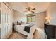 Neutral bedroom with carpet, a ceiling fan, a queen bed, and a window with a wooded view at 360 Morning Star Ln, Lafayette, CO 80026