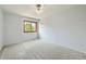 Minimalist bedroom with light blue walls, carpet, a window, and simple decor at 360 Morning Star Ln, Lafayette, CO 80026
