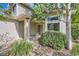 Inviting front entrance with white brick accents, stone landscaping, and shade trees at 360 Morning Star Ln, Lafayette, CO 80026