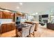 Open concept kitchen with island and barstool seating next to bright and airy living room at 360 Morning Star Ln, Lafayette, CO 80026
