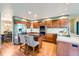 Traditional kitchen with cherry wood cabinetry, stainless steel appliances, and a breakfast bar with striped stools at 360 Morning Star Ln, Lafayette, CO 80026