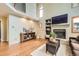 This living room features a cozy fireplace, wood floors, and built in shelves at 360 Morning Star Ln, Lafayette, CO 80026