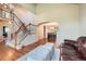 Open-concept living room with staircase, hardwood floors, and view into dining area at 360 Morning Star Ln, Lafayette, CO 80026