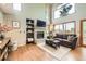 Bright living room boasts large windows, a brick fireplace, and a comfortable sofa at 360 Morning Star Ln, Lafayette, CO 80026