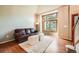 Cozy living room with hardwood floors, large windows, a leather sofa, and neutral decor at 360 Morning Star Ln, Lafayette, CO 80026