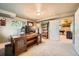 Office space featuring desk, shelving, and view into basement game room at 360 Morning Star Ln, Lafayette, CO 80026