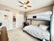 A cozy bedroom featuring a carpeted floor, a fan, a closet, and a black metal bunk bed at 12830 Jasmine St # A, Thornton, CO 80602