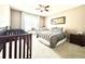 This cozy bedroom features two cribs, a bed, a ceiling fan, and a small desk and chair at 12830 Jasmine St # A, Thornton, CO 80602