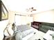 Bright bedroom with a sliding barn door, a ceiling fan, and two cribs at 12830 Jasmine St # A, Thornton, CO 80602