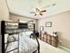 Cozy bedroom with a bunk bed, neutral decor, and a ceiling fan for added comfort at 12830 Jasmine St # A, Thornton, CO 80602