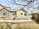 Cozy outdoor patio, perfect for relaxing, with a stone wall and sliding glass door access at 12830 Jasmine St # A, Thornton, CO 80602